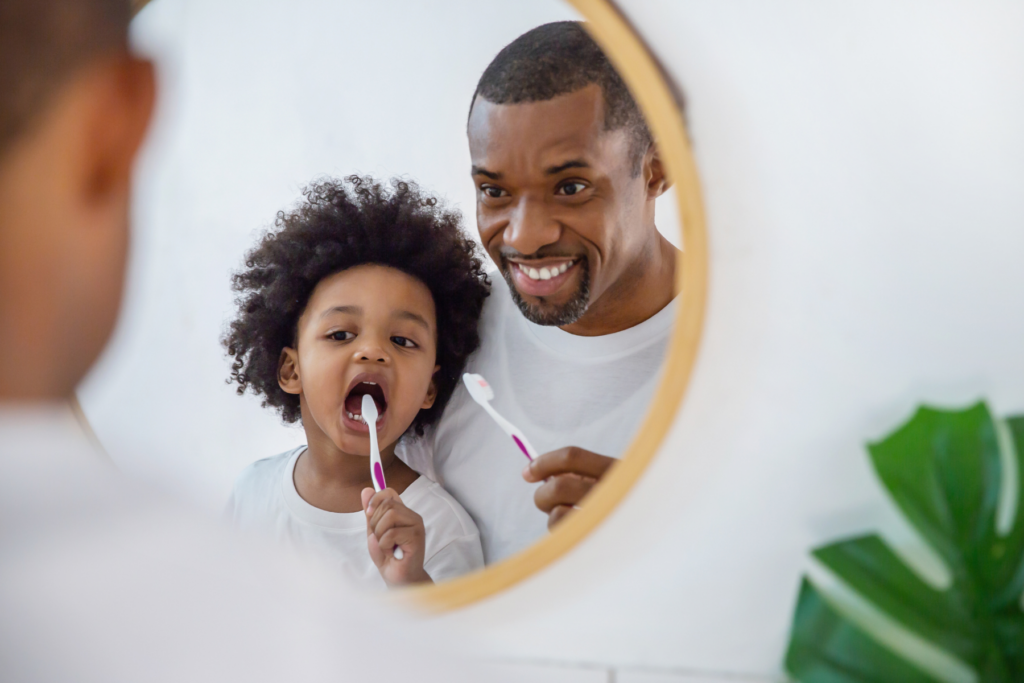 Father and son brushing teeth