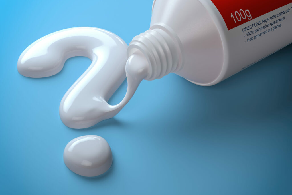 Tube of Toothpaste With Squeezed Out Toothpaste Formed into a Question Mark