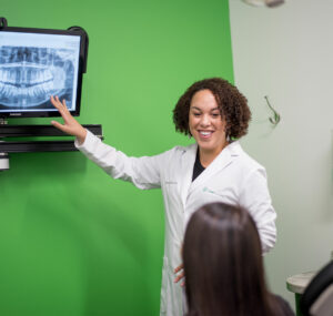 female dentist reviewing x-rays
